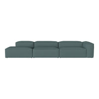 Stylish sectional sofa in muted teal fabric with a modern, minimalist design.