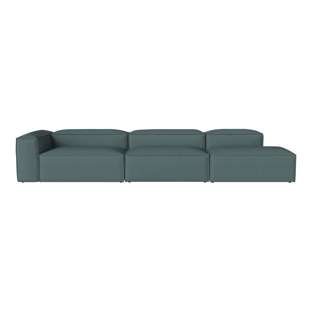 Modern teal modular sofa with a clean, minimalist design and solid color upholstery for versatile decor.
