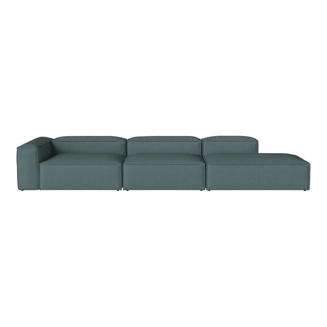 Stylish sectional sofa in a deep teal color with a modern, minimalist design and smooth, tailored upholstery.