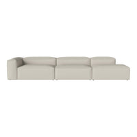 Light beige sectional sofa with a minimalistic design and smooth, solid fabric surface.