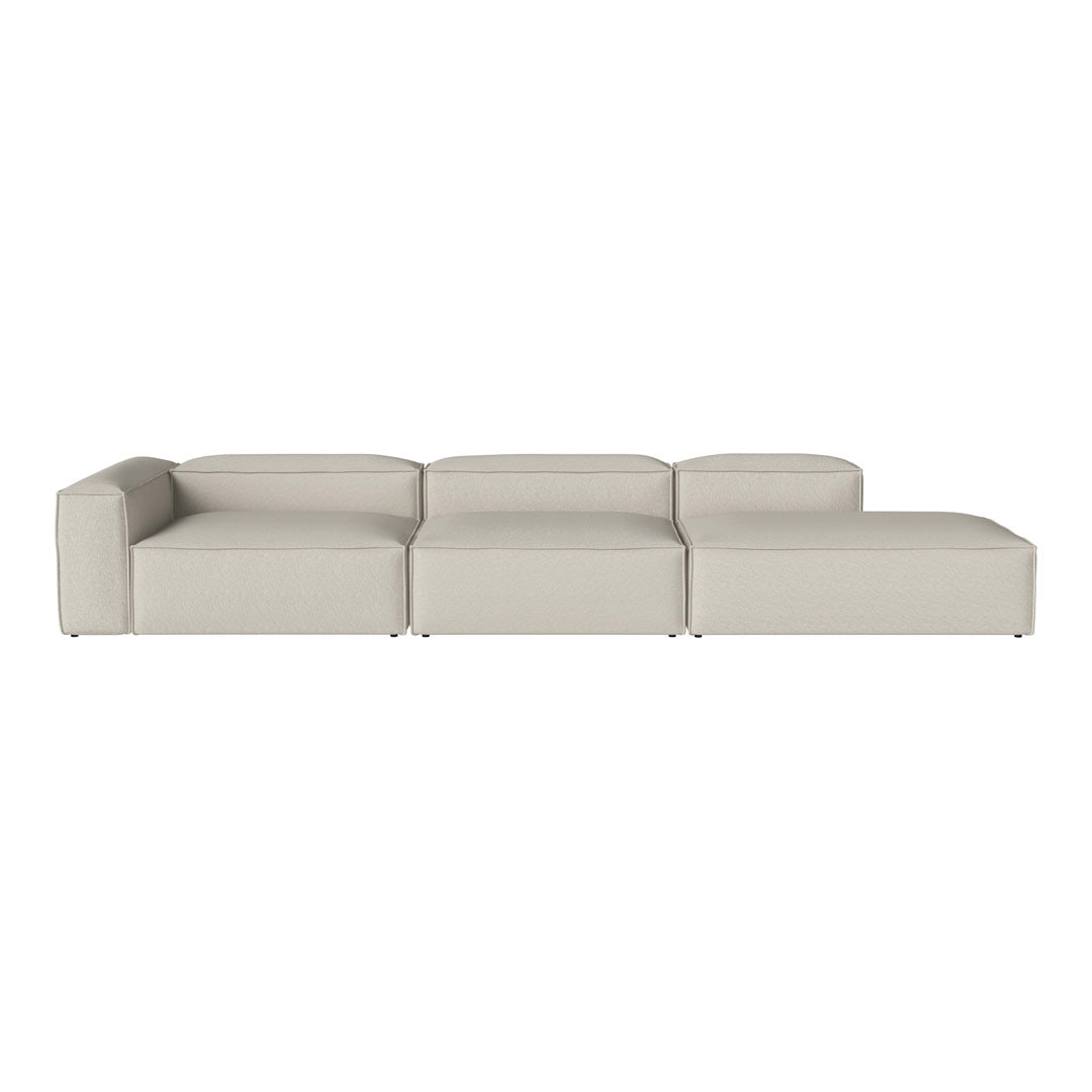 Modern beige sectional sofa with clean lines and minimalistic design, featuring smooth, textured upholstery.