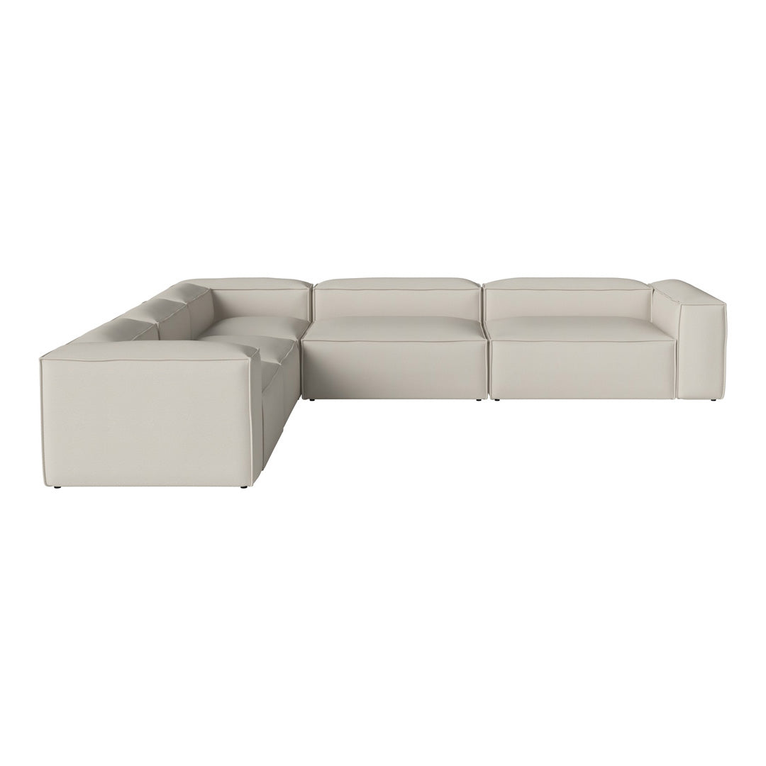 "Modern L-shaped sofa in a soft cream color with sleek, minimalistic design."