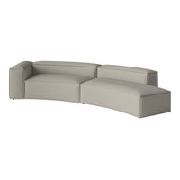 Curved gray sofa with a textured fabric, featuring a minimalist design and soft, neutral tones for modern decor.