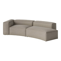 Curved sectional sofa in soft beige fabric with subtle ribbed texture, perfect for modern living spaces.