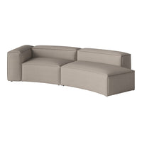 Beige curved modular sofa with a smooth, minimalist design and soft fabric upholstery.