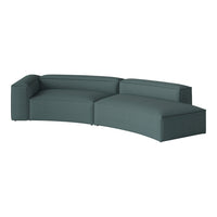 Teal upholstered sectional sofa with a contemporary, curved design and textured fabric for modern decor.