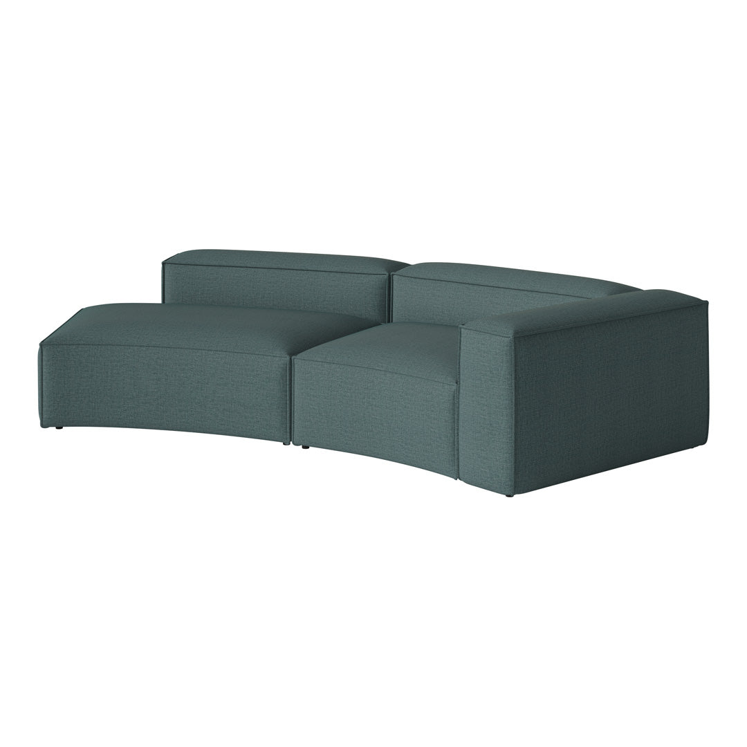 Textured teal sectional sofa with modern curved design, perfect for contemporary living spaces.