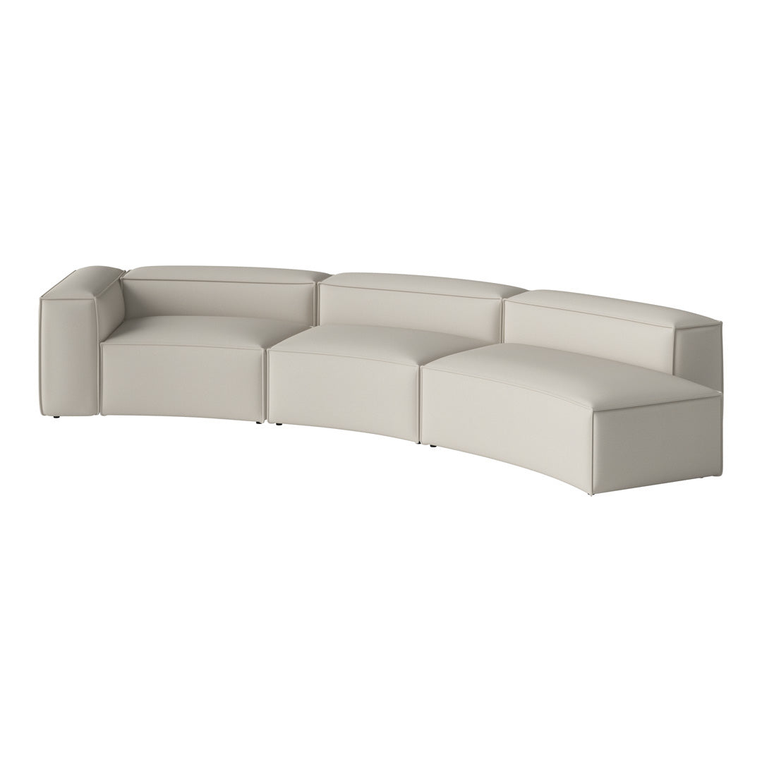 Curved sectional sofa in a soft beige color with a sleek, minimalist design and smooth leather upholstery.