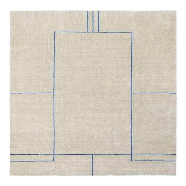 Beige linen rug with geometric blue pattern, featuring outlined rectangles and straight lines.