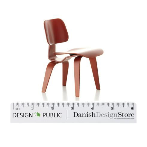 Red molded chair with smooth finish and minimalist design, perfect for modern decor.