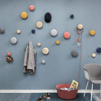Colorful wall decor featuring pastel circles in blue, gray, yellow, pink, and navy, enhancing modern interiors.