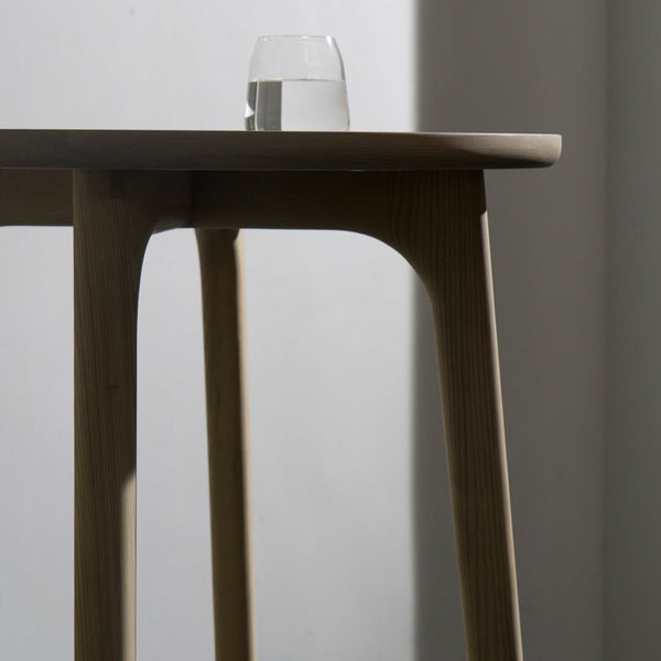 Light wooden table with smooth finish, featuring a minimalist design and a shadowed area for a modern feel.