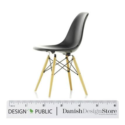 Black molded plastic chair with light wooden legs and a minimalist design, featuring a sleek, modern silhouette.