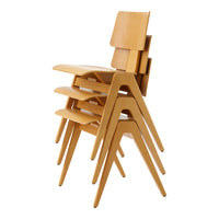 Stacked chairs in natural wood finish with smooth lines and a minimalist design, showcasing a warm, light color.