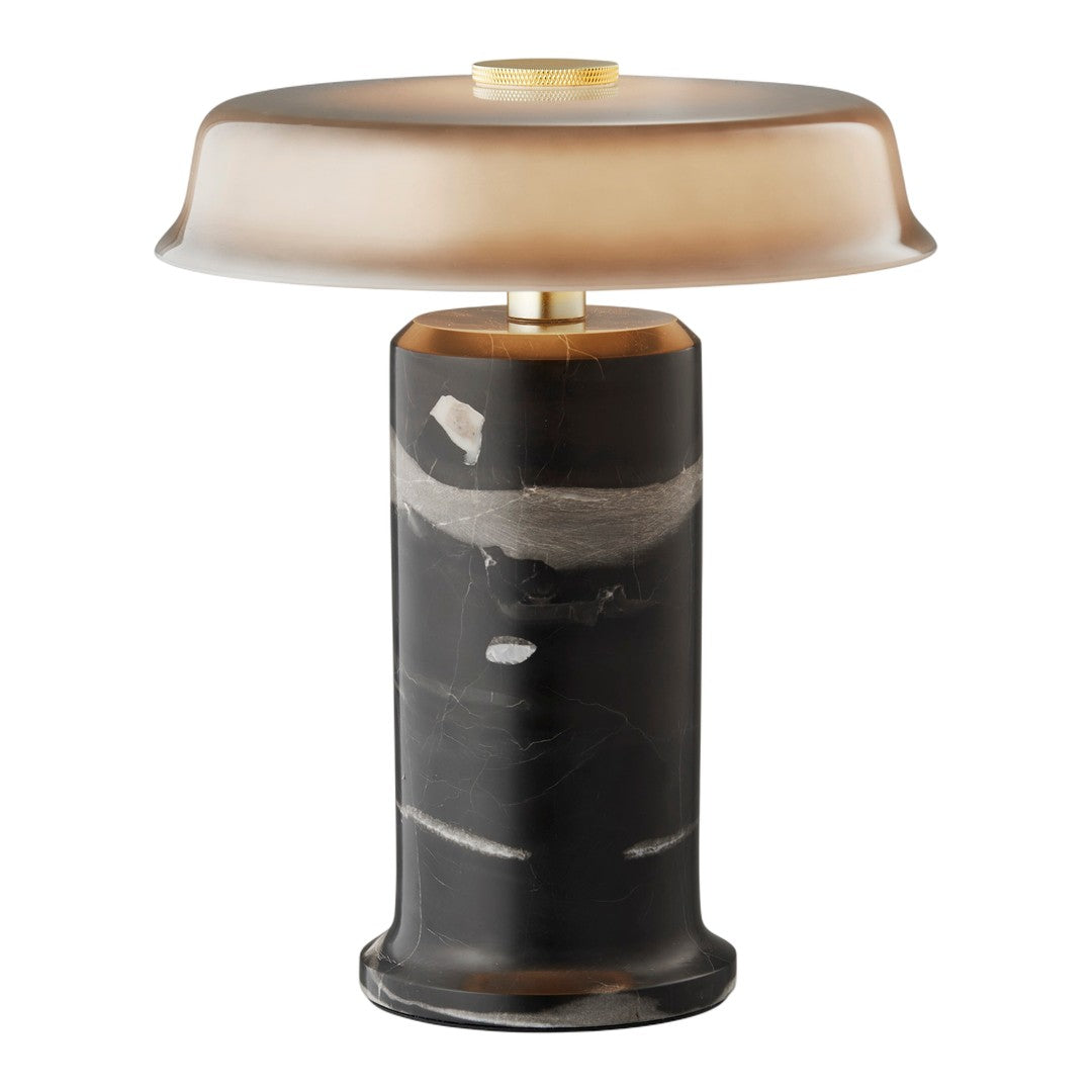 Modern lamp featuring a smooth, gradient amber shade and a textured black and white patterned base. Elegant and stylish.