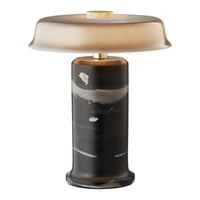 Modern lamp featuring a smooth, gradient amber shade and a textured black and white patterned base. Elegant and stylish.