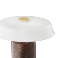 White frosted lamp shade atop a marbled reddish-brown base with a sleek gold accent. Elegant and modern design.