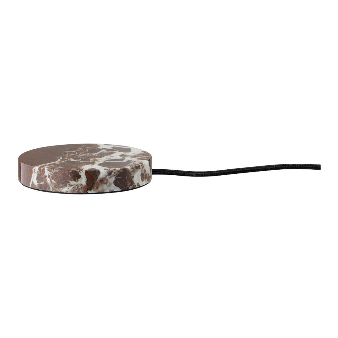 Brown marble patterned surface with shades of white and a black cord, round design, modern aesthetic.