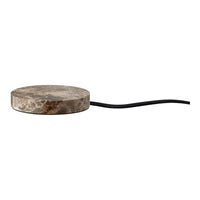 Round stone-like base in natural gray tones with a sleek black cord. Perfect for modern home decor.