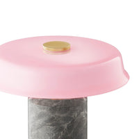 Pink dome-shaped lid with a gold accent atop a textured gray marble base. Modern and stylish design.