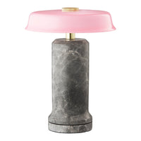 Gray marble lamp base with a glossy pink dome shade, offering a modern and stylish contrast in colors and textures.