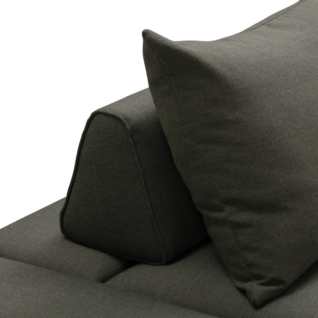Dark gray sofa cushion with a unique angled design and textured fabric, enhancing modern decor aesthetics.