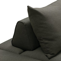 Dark gray sofa cushion with a unique angled design and textured fabric, enhancing modern decor aesthetics.