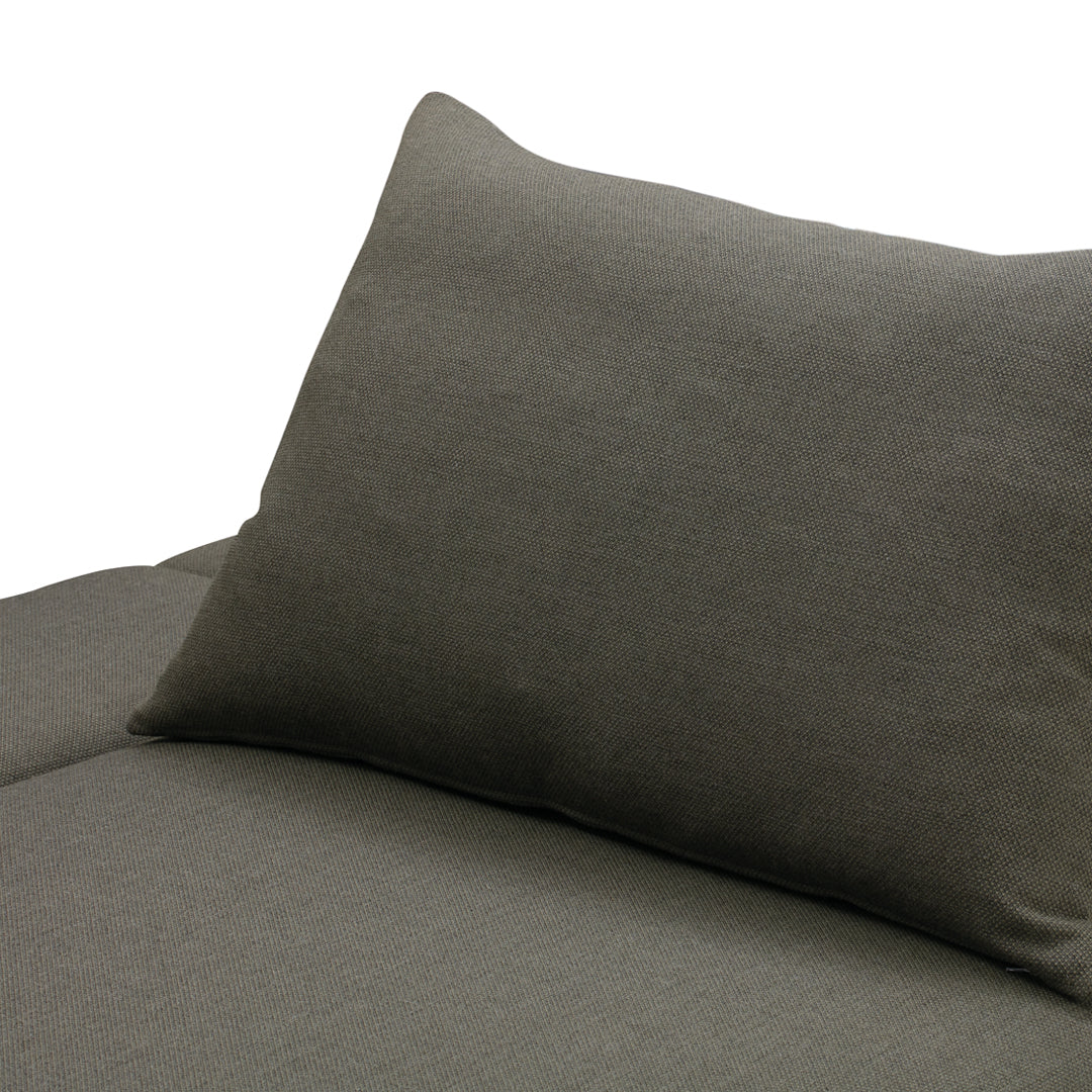 Dark gray textured fabric pillow on a coordinating sofa cushion, creating a modern, minimalist look.