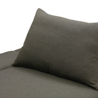 Dark gray textured fabric pillow on a coordinating sofa cushion, creating a modern, minimalist look.