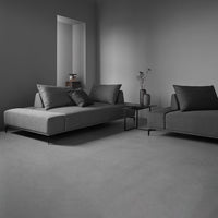 Modern gray sectional sofas with sleek lines and contrasting black accents in a minimalist living space.