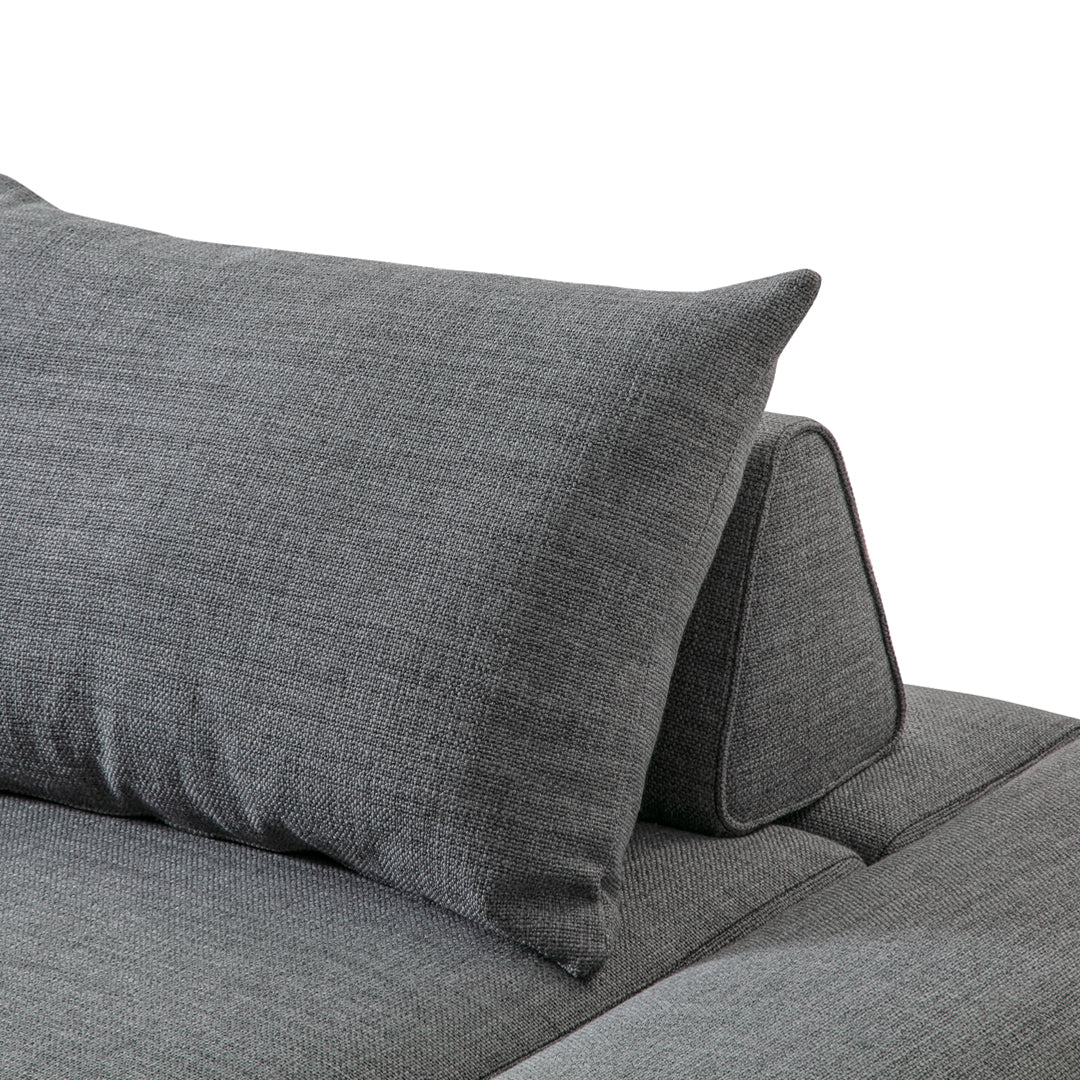 Gray textured fabric pillow and backrest on a modern sofa, showcasing a sleek and contemporary design.