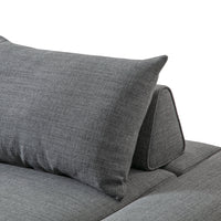 Gray textured fabric pillow and backrest on a modern sofa, showcasing a sleek and contemporary design.