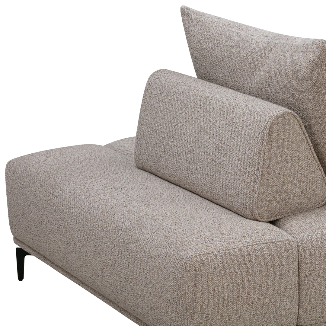 Beige fabric sofa with a subtle textured pattern, featuring a modern design and angled back cushions.