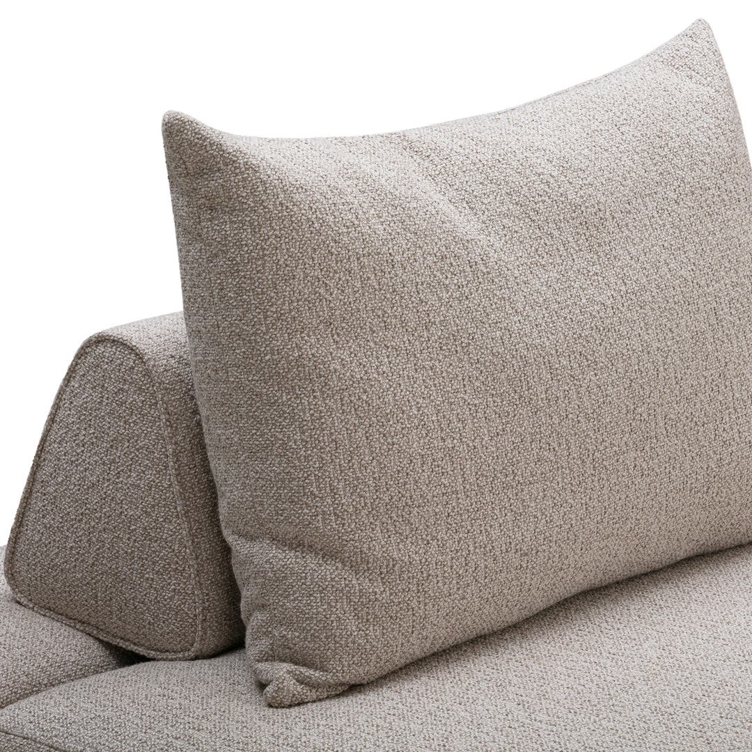 Light beige textured fabric sofa with a plush, patterned cushion for a cozy, modern look.
