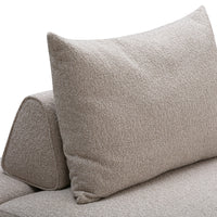 Light beige textured fabric sofa with a plush, patterned cushion for a cozy, modern look.