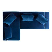 Deep navy blue sectional sofa with plush cushions in a smooth velvet finish.