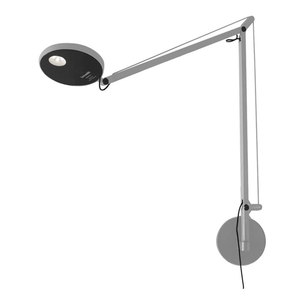 Black and silver modern wall lamp with a sleek arm and round base, designed for stylish illumination.
