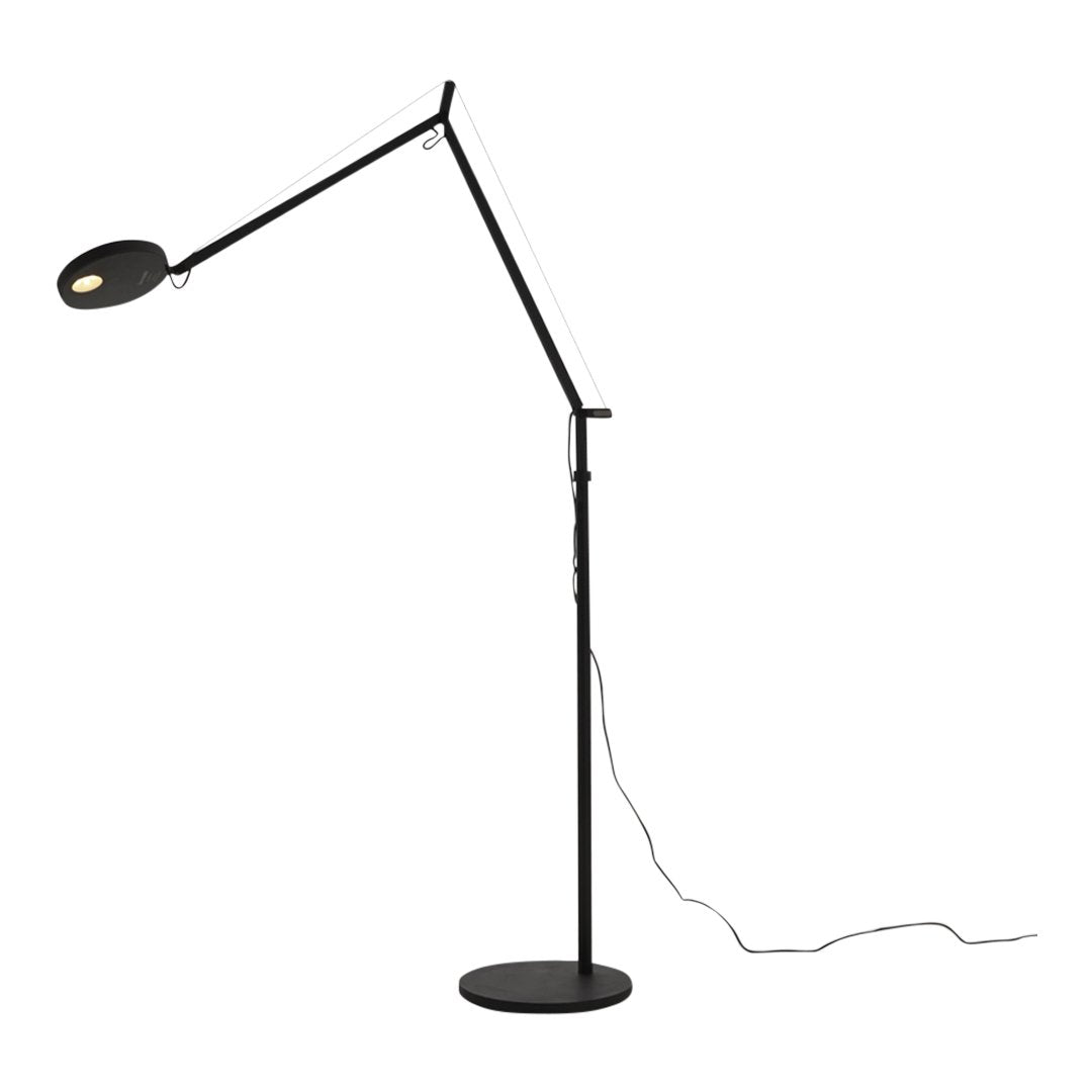 Black and white adjustable floor lamp with a sleek, modern design and a circular light head.