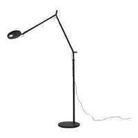 Black and white adjustable floor lamp with a sleek, modern design and a circular light head.
