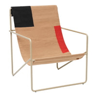 Beige chair with bold black and red geometric patterns, featuring a minimalist metal frame. Modern design accent piece.