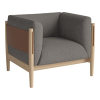 Gray upholstered armchair with brown leather accents and a light wooden frame, featuring modern, minimalist design.