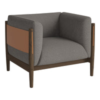 Gray upholstered armchair with a brown leather side pocket and dark wood frame, featuring modern, clean lines.