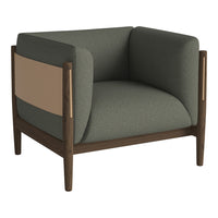 Stylish armchair in muted green fabric with beige and natural wood accents, featuring a modern, minimalist design.
