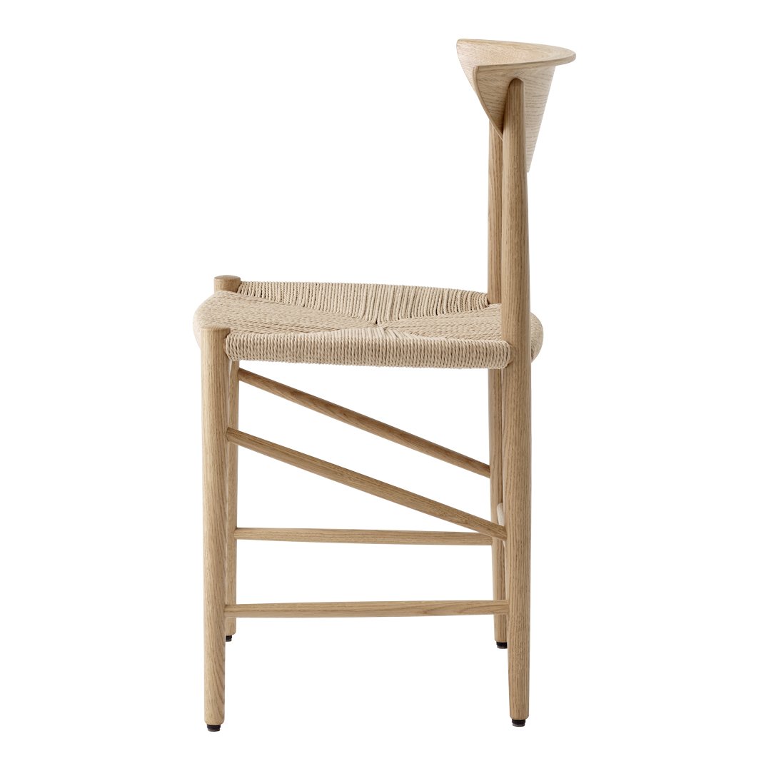 Natural wood chair with woven seat, featuring a minimalist design and soft neutral tones.