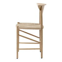 Natural wood chair with woven seat, featuring a minimalist design and soft neutral tones.