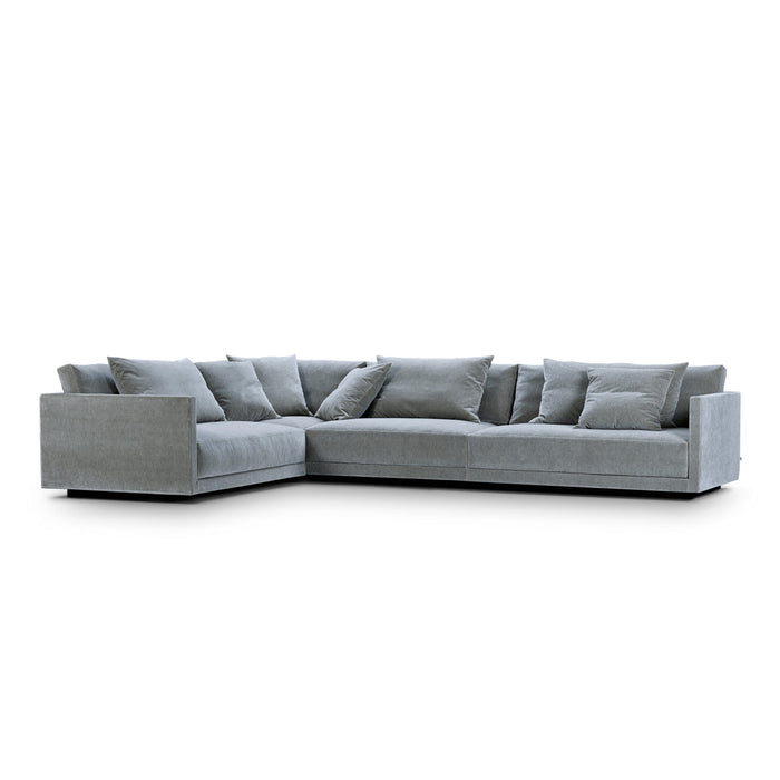 Light gray sectional sofa with a modern design, featuring plush cushions and a minimalist aesthetic.