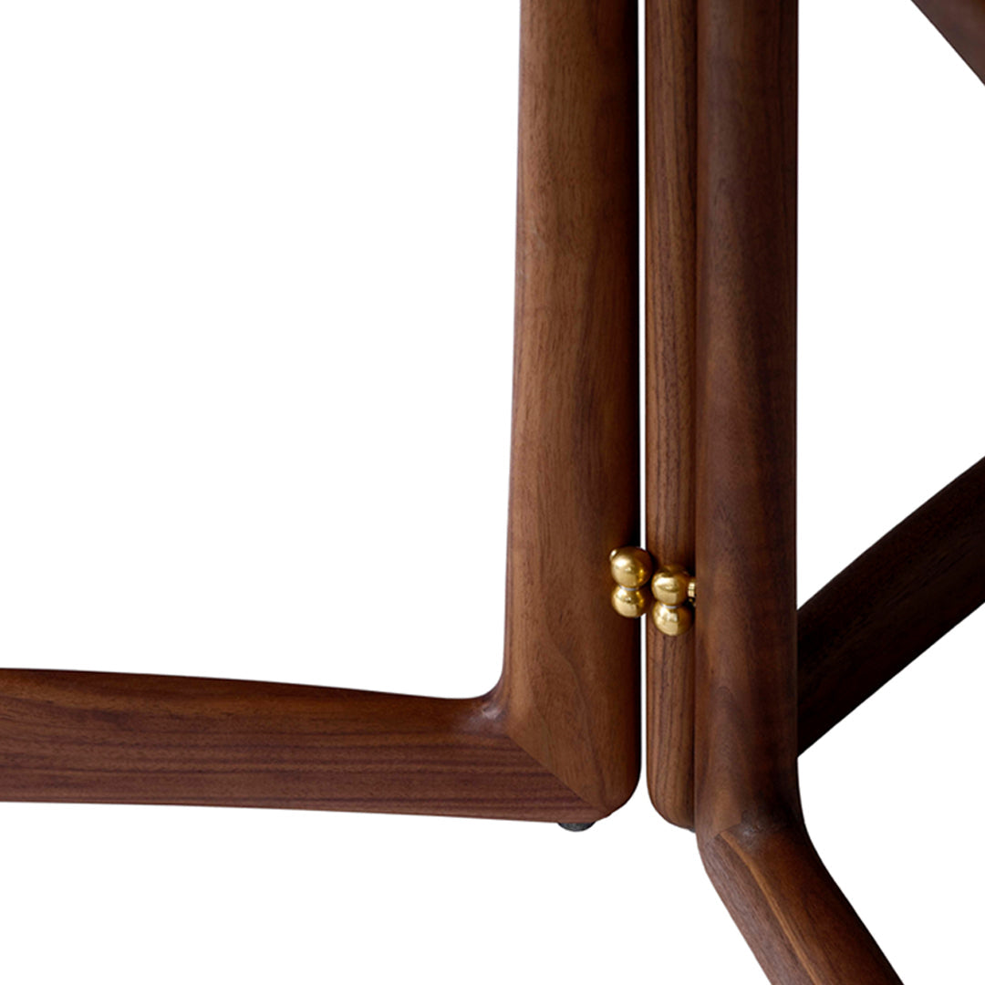 Close-up of sleek walnut wood frame with elegant golden accents, showcasing natural grain patterns.