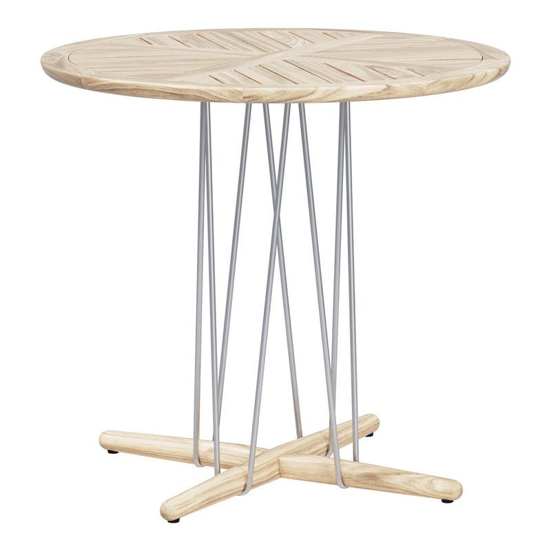 Round wooden table with a light natural finish and geometric patterns, featuring sleek silver metal legs.