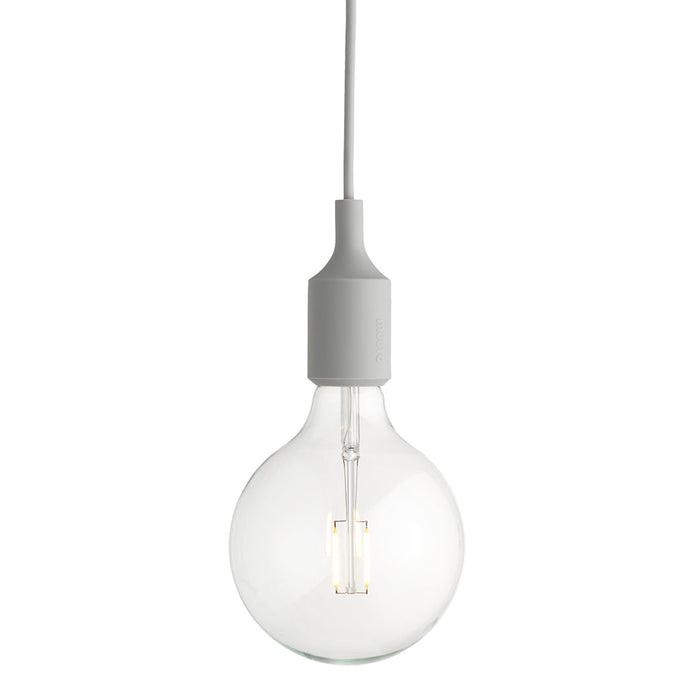Clear glass pendant light with a sleek white socket and cord, offering a minimalist and modern design.
