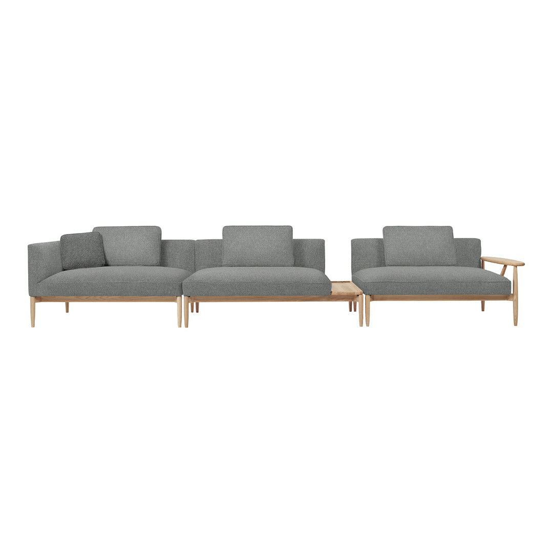 Modern sectional sofa in soft gray fabric with a minimalist design and light wood accents. Perfect for contemporary spaces.